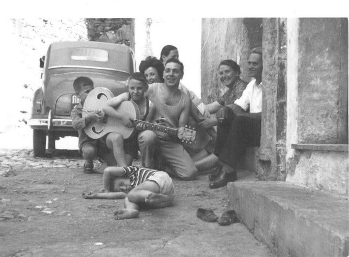 Giovanni Monoscalco as a child holding a guitar, Italy, early 1960s